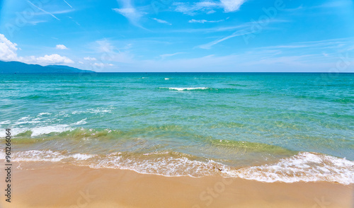 Azure sea waves on the sand beach.