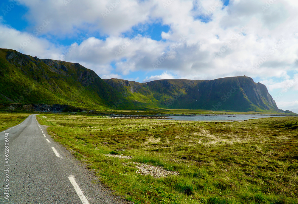 Scenic road through green valley with mountains on Andøya, Northern Norway Scenic road through green valley with mountains on Andøya, Northern Norway