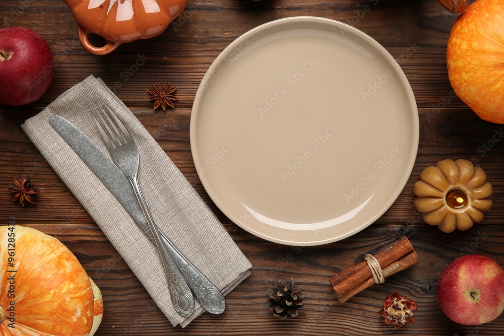 Stylish place setting and autumn decor on wooden table Stylish place setting and autumn decor on wooden table