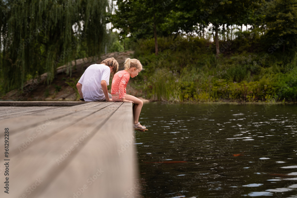 Children Enjoy Looking At The Fish On The Dock At The Gathering Place Children Enjoy Looking At The Fish On The Dock At The Gathering Place