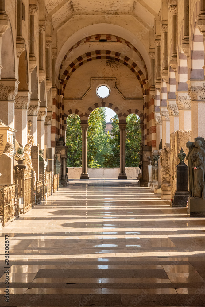 perspective view of one of the corridors with columns and arches at the cemetery of Milano, in Italy