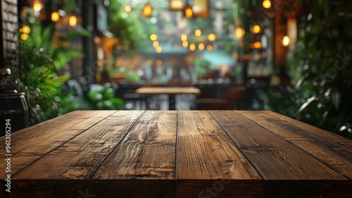 Empty wooden table in the foreground with a cozy coffee shop blurred in the background.