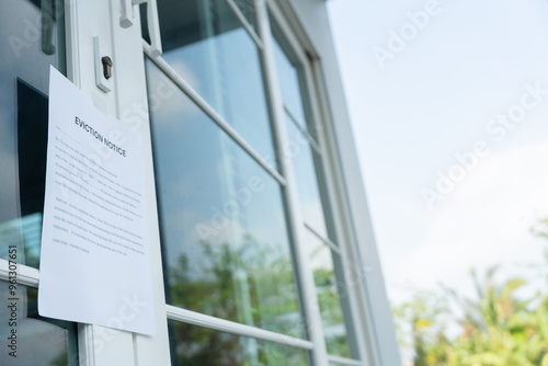 document with the text eviction notice, Civil servant sticks a notice of eviction of the tenants hangs on the door of the house, debt, property, loan, agent, bankruptcy, dispossess, problem. photo