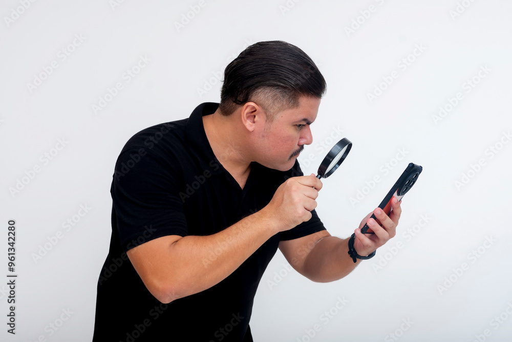 A middle-aged man using a magnifying glass to read small fine text while browsing website or social media on his phone. Delving or overanalyzing the details. Isolated on a white background. A middle-aged man using a magnifying glass to read small fine text while browsing website or social media on his phone. Delving or overanalyzing the details. Isolated on a white background.