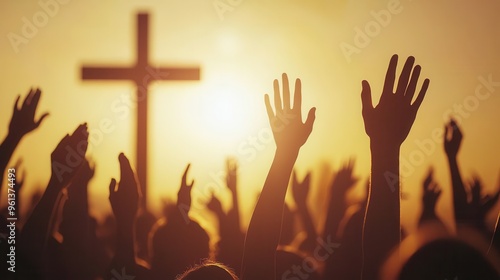 Silhouette of a Crowd Raising Hands in Prayer at Sunset with a Cross