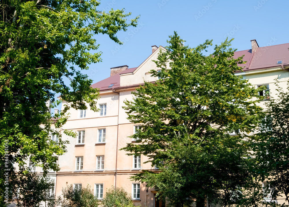 Fototapeta premium Apartment Building with Trees on a Sunny Day in the city of Lviv, Ukraine