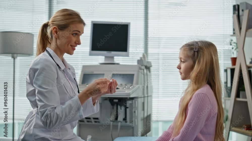 Smiling pediatrician giving high five to cute girl. Closeup child visit doctor Smiling pediatrician giving high five to cute girl. Closeup child visit doctor