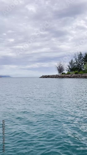 Seascape from moving boat on a sunny day. Beautiful skyscape. Vacation, travel, and holiday concept.
