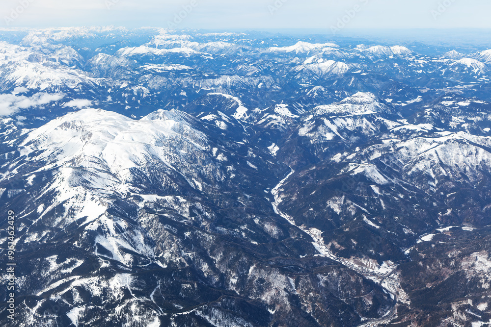 Obraz premium Aerial view of a majestic snowy mountain range. Alps mountains are covered in snow, view from above