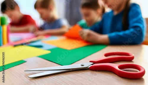 Wallpaper Mural Colored paper and scissors on front, blurred kids making paper carving are on background Torontodigital.ca