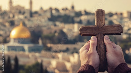 Hands holding wooden cross with holy site background