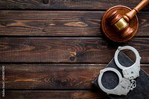Принти на полотні Metal handcuffs with judges gavel and criminal code book