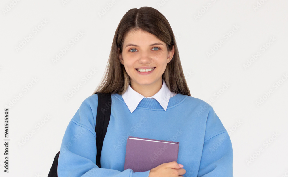 Obraz premium Caucasian girl student in blue sweatshirt with folder, books, notebook, notepad in hands smiling isolated on white studio background, copy space