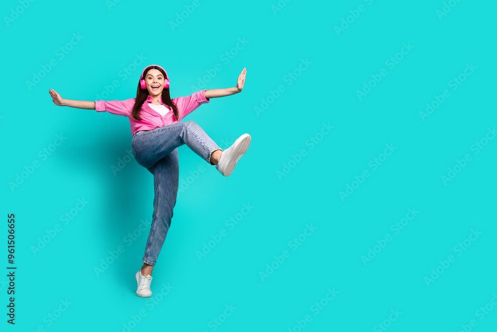Full body photo of lovely teen lady headphones dance step dressed stylish pink garment isolated on cyan color background Full body photo of lovely teen lady headphones dance step dressed stylish pink garment isolated on cyan color background