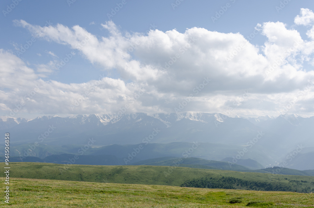Mountain slopes with clouds on the sky covered with valley on top and mountains in Altay Russia early in the evening sunset. Hight quality horizontal photo Mountain slopes with clouds on the sky covered with valley on top and mountains in Altay Russia early in the evening sunset. Hight quality horizontal photo