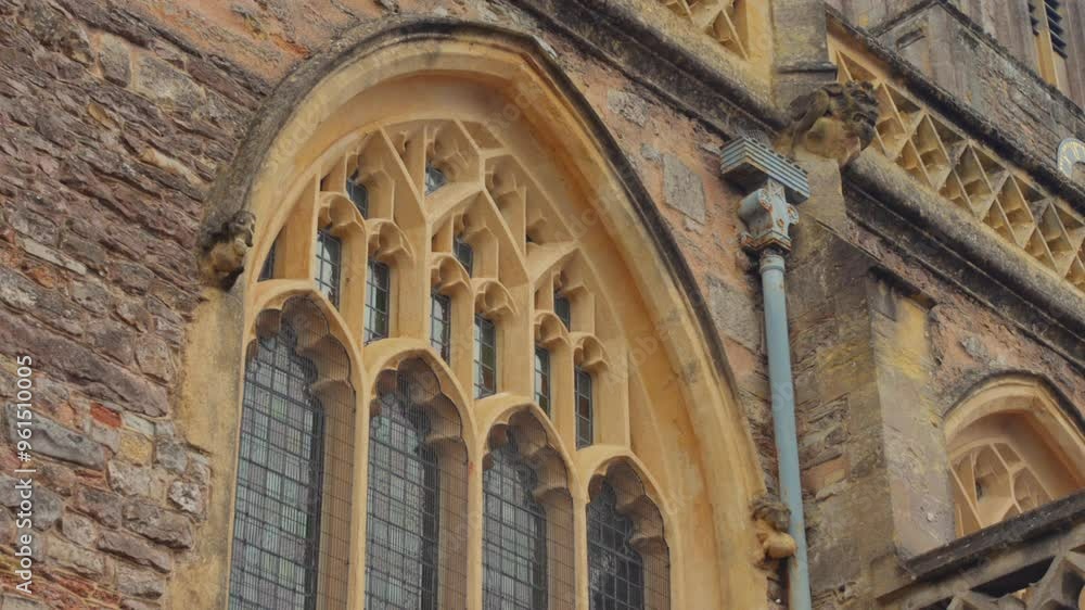 Decorative Window Details of Church of St John the Baptist In Axbridge, Somerset, UK. closeup, low-angle tilt-down Decorative Window Details of Church of St John the Baptist In Axbridge, Somerset, UK. closeup, low-angle tilt-down