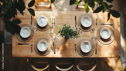 A top-down view of a minimalist dining table with simple, geometric place settings