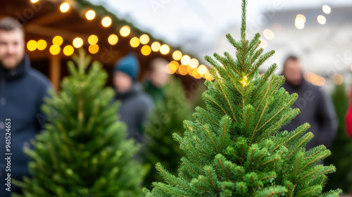 Bustling Christmas tree market with families picking out fresh evergreens, colorful lights strung above, festive atmosphere 