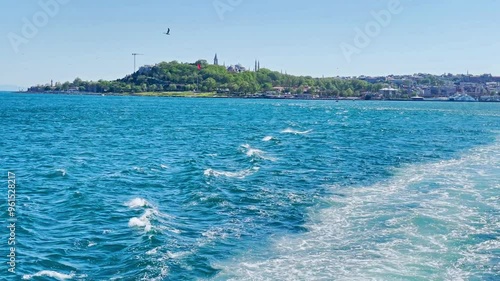 Istanbul city from sea. Wave trail from speed travel boat on blue sea. 4K video clip