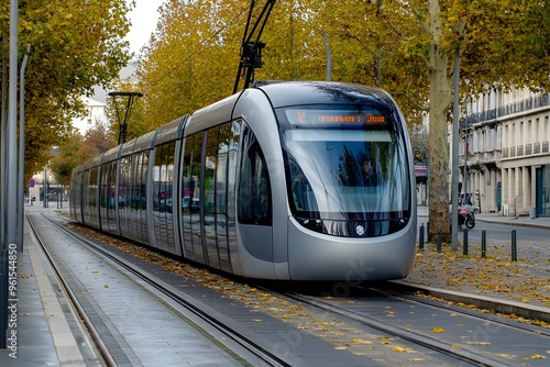 Fototapeta Naklejka Na Ścianę i Meble -  Modern Tram on Tracks with Fall Foliage