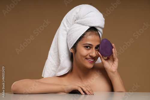woman in bathrobe holding soap