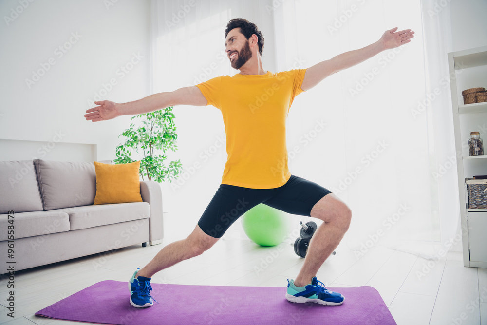Fototapeta premium Photo of handsome good mood guy wear yellow t-shirt doing morning sport exercises enjoying balance tasks indoors room home house