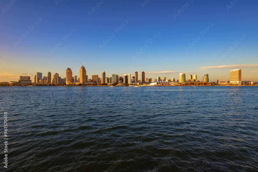 San Diego skyline viewed from Coronado Island across the bay during sunset, with clear skies San Diego skyline viewed from Coronado Island across the bay during sunset, with clear skies