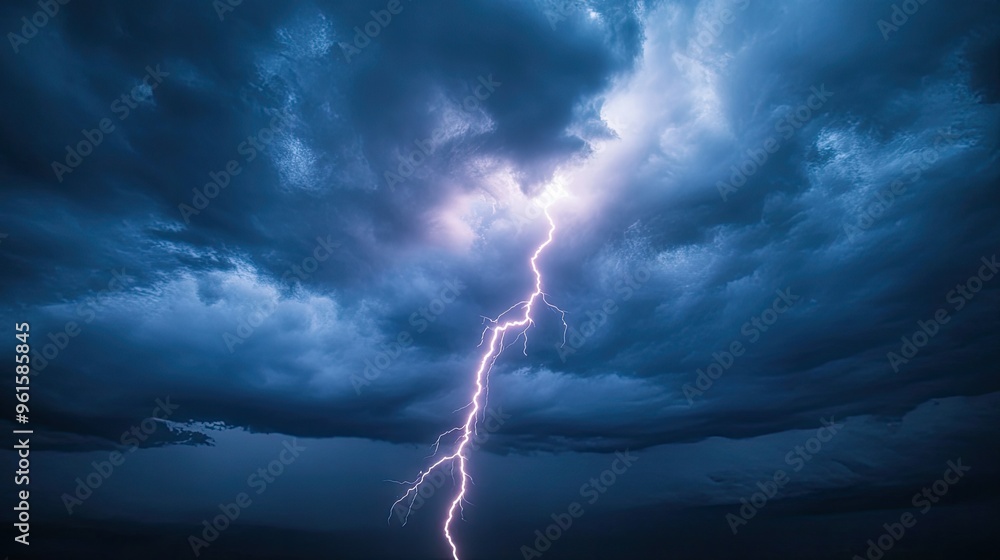 Cloud-to-ground lightning bolt captured mid-strike, with the bolt creating a vivid contrast against the stormy sky. Cloud-to-ground lightning bolt captured mid-strike, with the bolt creating a vivid contrast against the stormy sky.