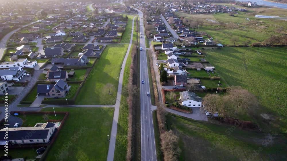 Cars navigating a street in a small suburban Danish city, showcasing urban life. Cars navigating a street in a small suburban Danish city, showcasing urban life.