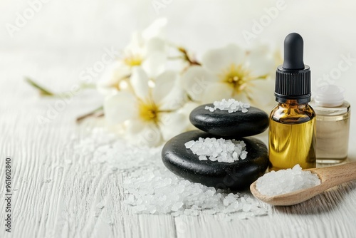 Beauty treatment items for spa procedures on white wooden table. massage stones, essential oils and sea salt