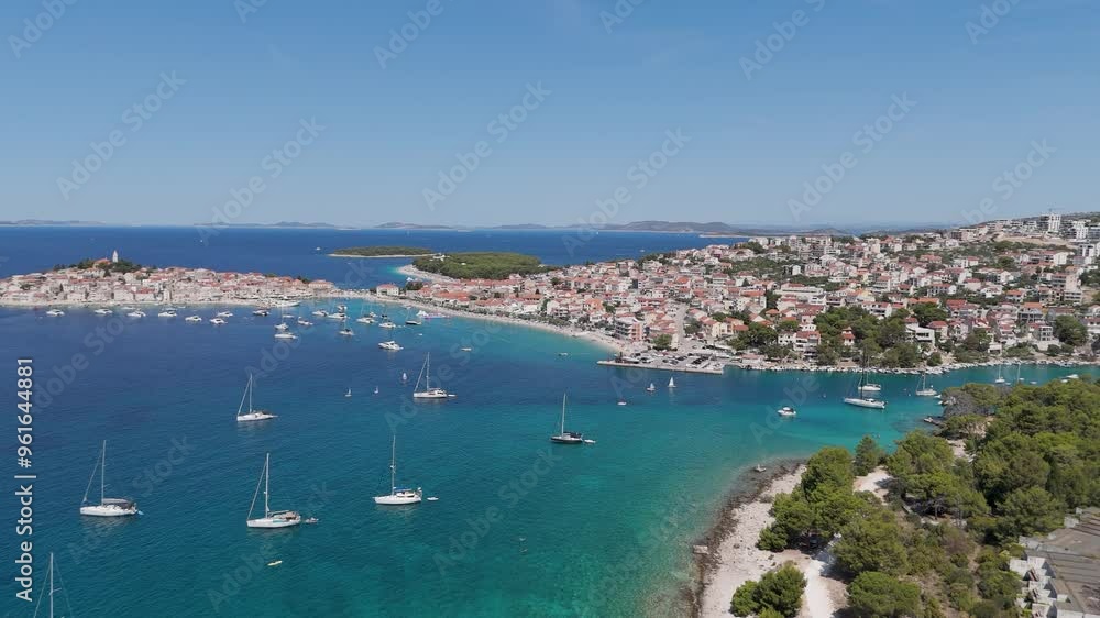 Aerial View of the Primosten Town, Adriatic Sea, Croatia. Idyllic Beach on Mediterranean Sea Coast Near Medieval Primosten City in Croatia. Summer Holidays Travel Destination. Blue Sky, Azure Water. Aerial View of the Primosten Town, Adriatic Sea, Croatia. Idyllic Beach on Mediterranean Sea Coast Near Medieval Primosten City in Croatia. Summer Holidays Travel Destination. Blue Sky, Azure Water.