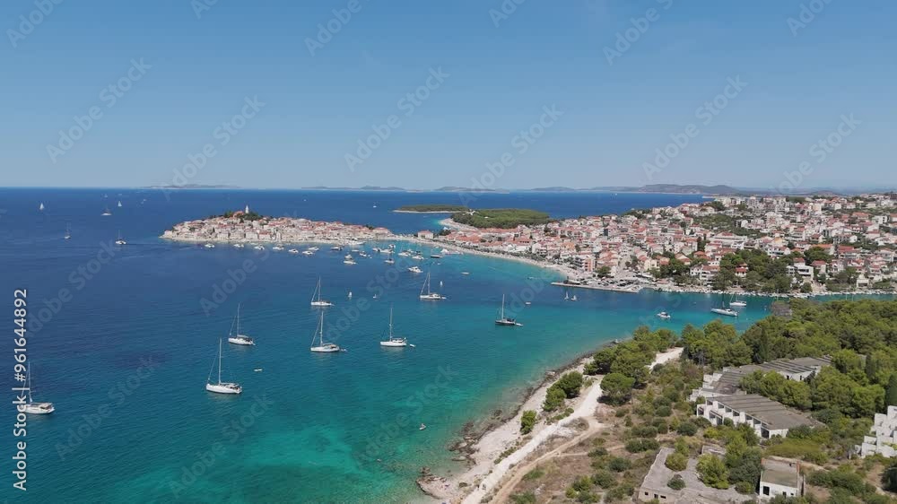 Aerial View of the Primosten Town, Adriatic Sea, Croatia. Idyllic Beach on Mediterranean Sea Coast Near Medieval Primosten City in Croatia. Summer Holidays Travel Destination. Blue Sky, Azure Water. Aerial View of the Primosten Town, Adriatic Sea, Croatia. Idyllic Beach on Mediterranean Sea Coast Near Medieval Primosten City in Croatia. Summer Holidays Travel Destination. Blue Sky, Azure Water.