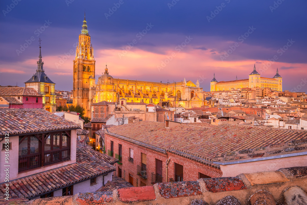 Toledo, Spain - Castilla la Mancha. Dramatic aerial view of the medieval Toledo Cathedral and Alcazar fortress, twilight colored sky.