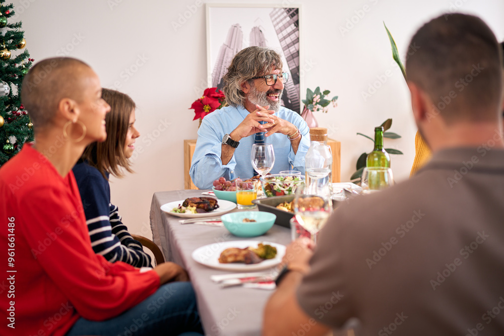 Christmas meal of happy Caucasian family enjoying drinks and food together sitting relaxed at table at home. Cheerful diverse people gathered at festive winter lunch having fun doing domestic life Christmas meal of happy Caucasian family enjoying drinks and food together sitting relaxed at table at home. Cheerful diverse people gathered at festive winter lunch having fun doing domestic life