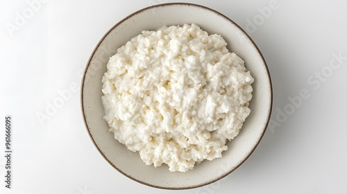 Creamy cottage cheese in rustic bowl on light background photo