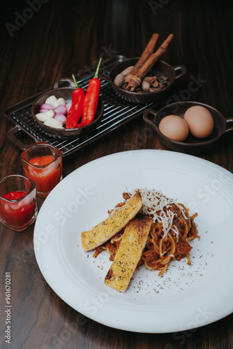 Pasta serving on white plat and chili. A classic Italian pasta dish made with simple tomato sauce, garlic, and basil, often garnished with Parmesan cheese. It’s light, fresh, and timeless.Side view photo