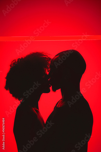 A couple kissing in a red background