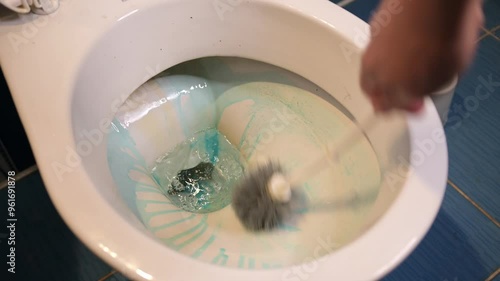 A dirty toilet is cleaned by applying gel chemicals and scrubbing with a brush.