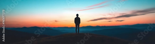 A silhouette of a person standing on a hilltop at dusk, their shadow blending into the twilight sky The mood is contemplative and serene