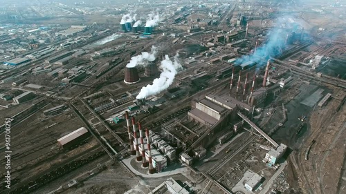 aerial view of industrial zone with factories expelling smoke around a green landscape 2 photo