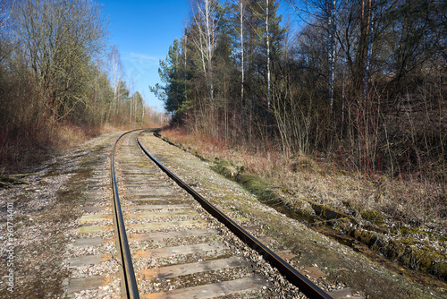 Railway track in the spring forest with blue sky with railway drainage system rail construction. Rail trackside drainage. Drainage channels of railway. photo