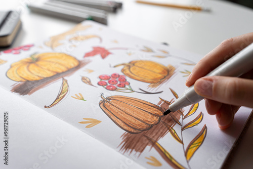 Hand coloring autumn illustration with markers