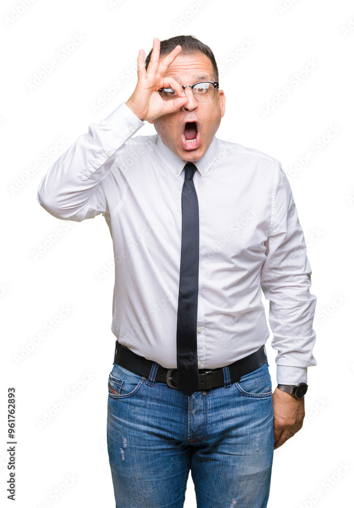 Middle age bussines arab man wearing glasses over isolated background doing ok gesture shocked with surprised face, eye looking through fingers. Unbelieving expression. Middle age bussines arab man wearing glasses over isolated background doing ok gesture shocked with surprised face, eye looking through fingers. Unbelieving expression.