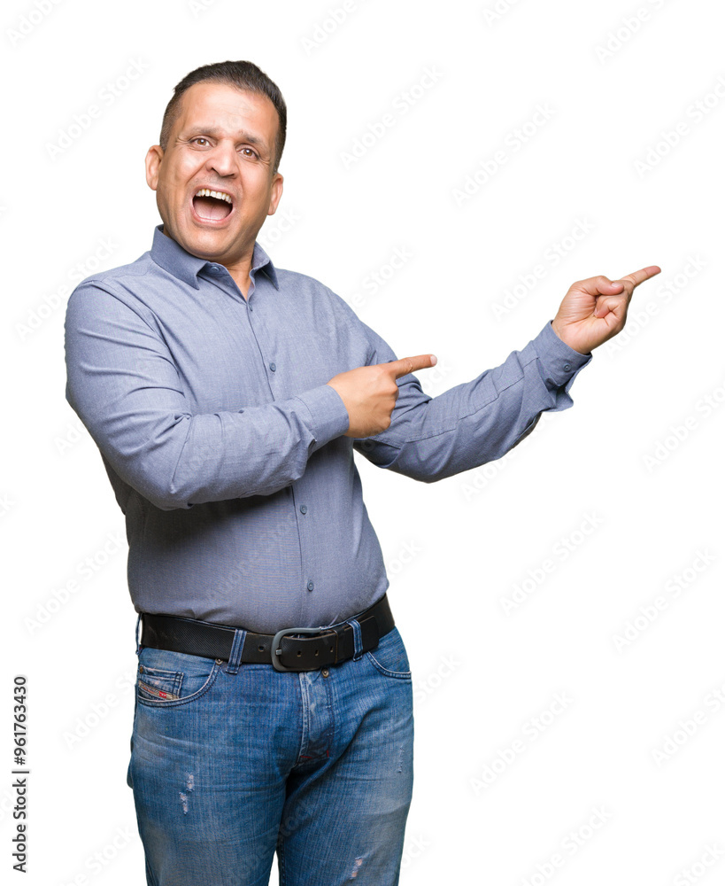 Middle age arab business man over isolated background amazed and smiling to the camera while presenting with hand and pointing with finger. Middle age arab business man over isolated background amazed and smiling to the camera while presenting with hand and pointing with finger.