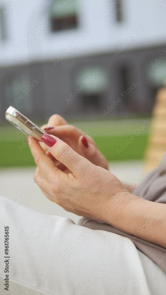 A person using a smartphone outdoors in a modern urban setting, enjoying the experience A person using a smartphone outdoors in a modern urban setting, enjoying the experience