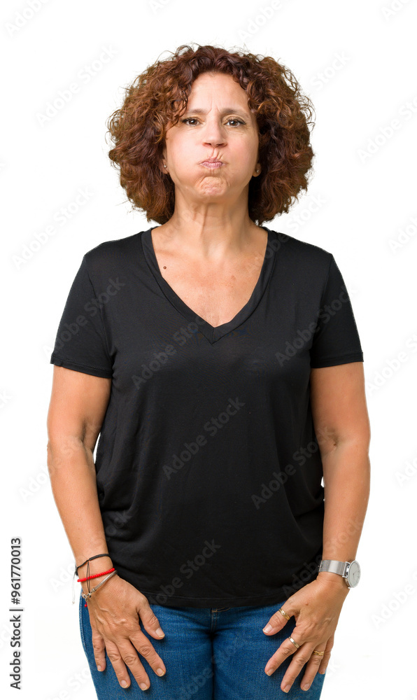 Fototapeta premium Beautiful middle ager senior woman over isolated background puffing cheeks with funny face. Mouth inflated with air, crazy expression.
