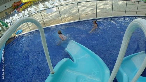 Little girls sliding down a water slide