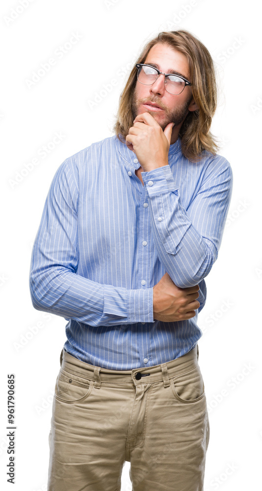 Young handsome man with long hair wearing glasses over isolated background with hand on chin thinking about question, pensive expression. Smiling with thoughtful face. Doubt concept. Young handsome man with long hair wearing glasses over isolated background with hand on chin thinking about question, pensive expression. Smiling with thoughtful face. Doubt concept.
