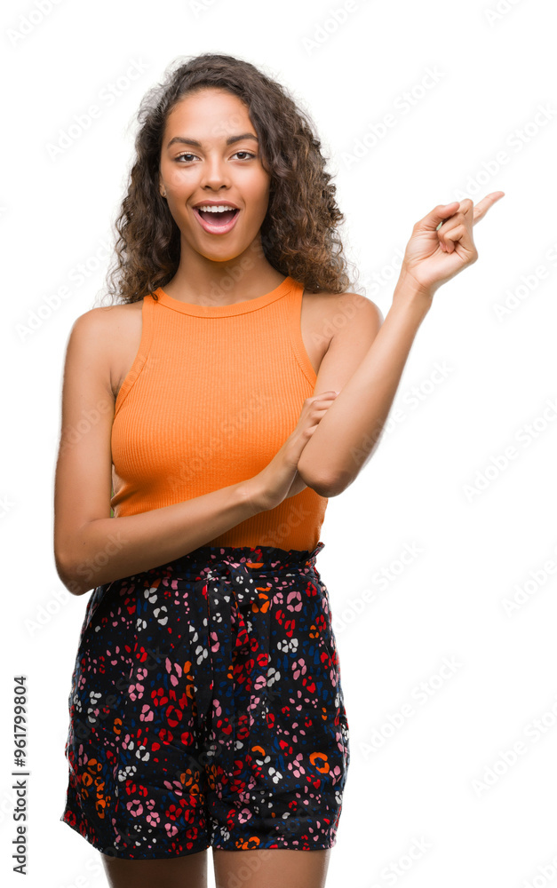 Young hispanic woman very happy pointing with hand and finger to the side Young hispanic woman very happy pointing with hand and finger to the side