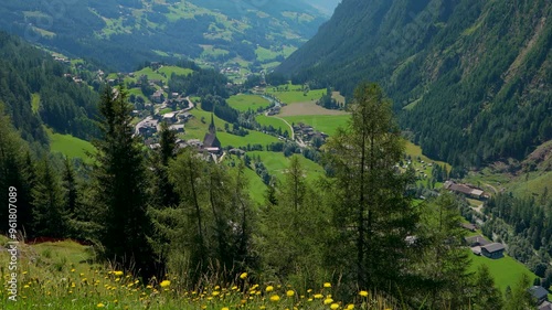  Beautiful village of Heiligenblut in valley among high mountains. Not far from highest mountain Grossglockner and famous grossglockner high alpine road. Austria.  photo